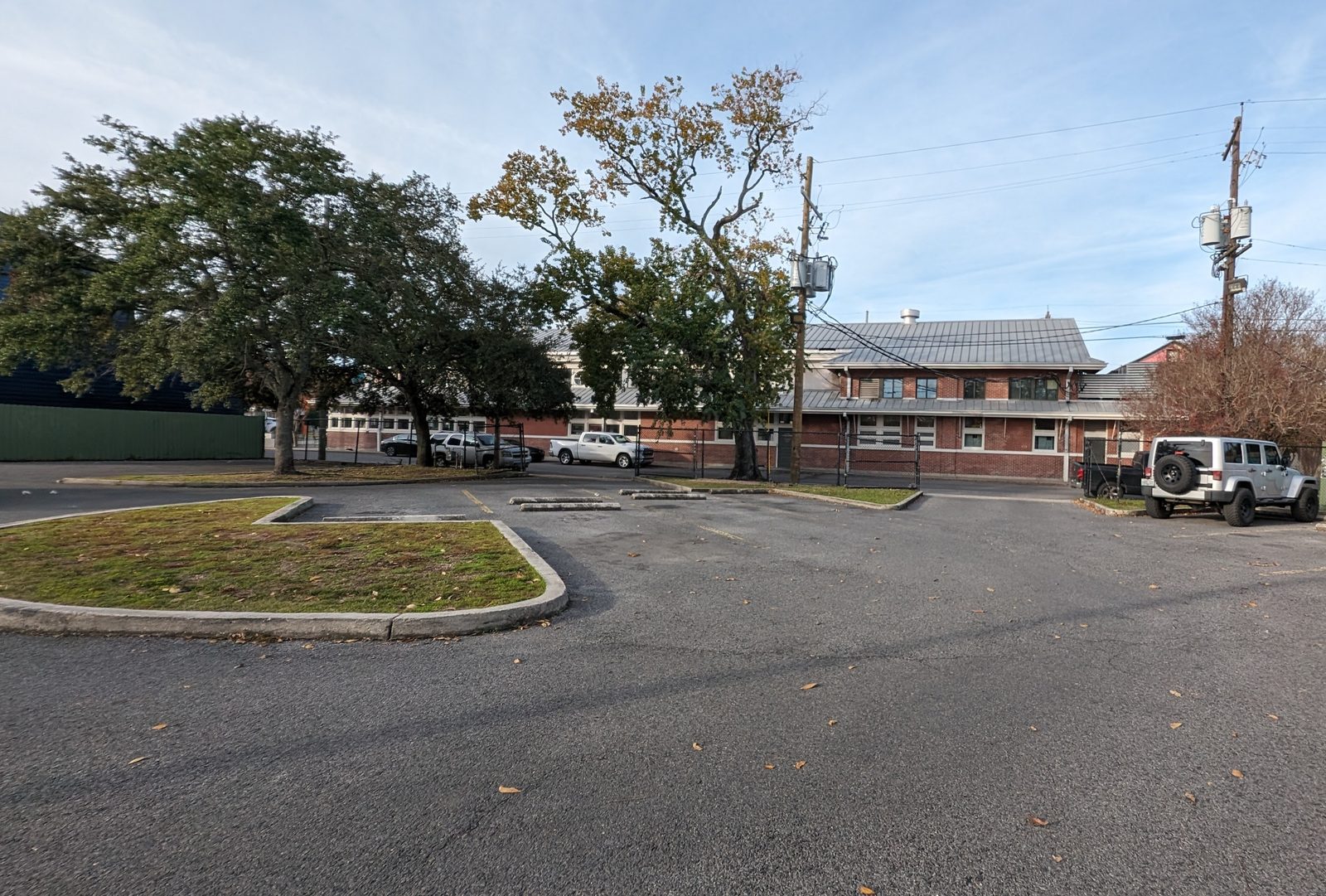 Free private parking lot at St. Roch Market with the historic building visible through the trees